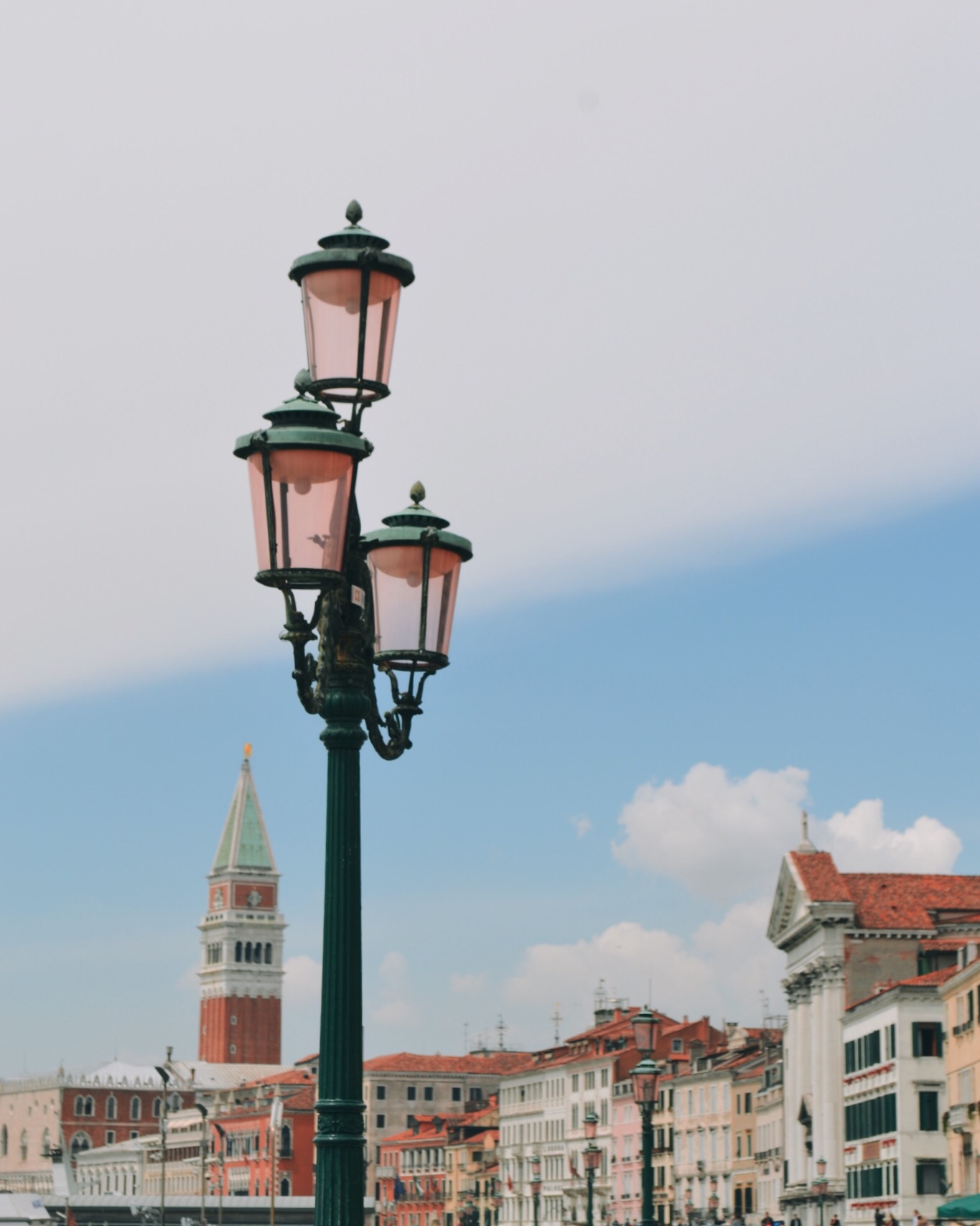 Close up of vintage lamp post in europe with a blurred background of a city street