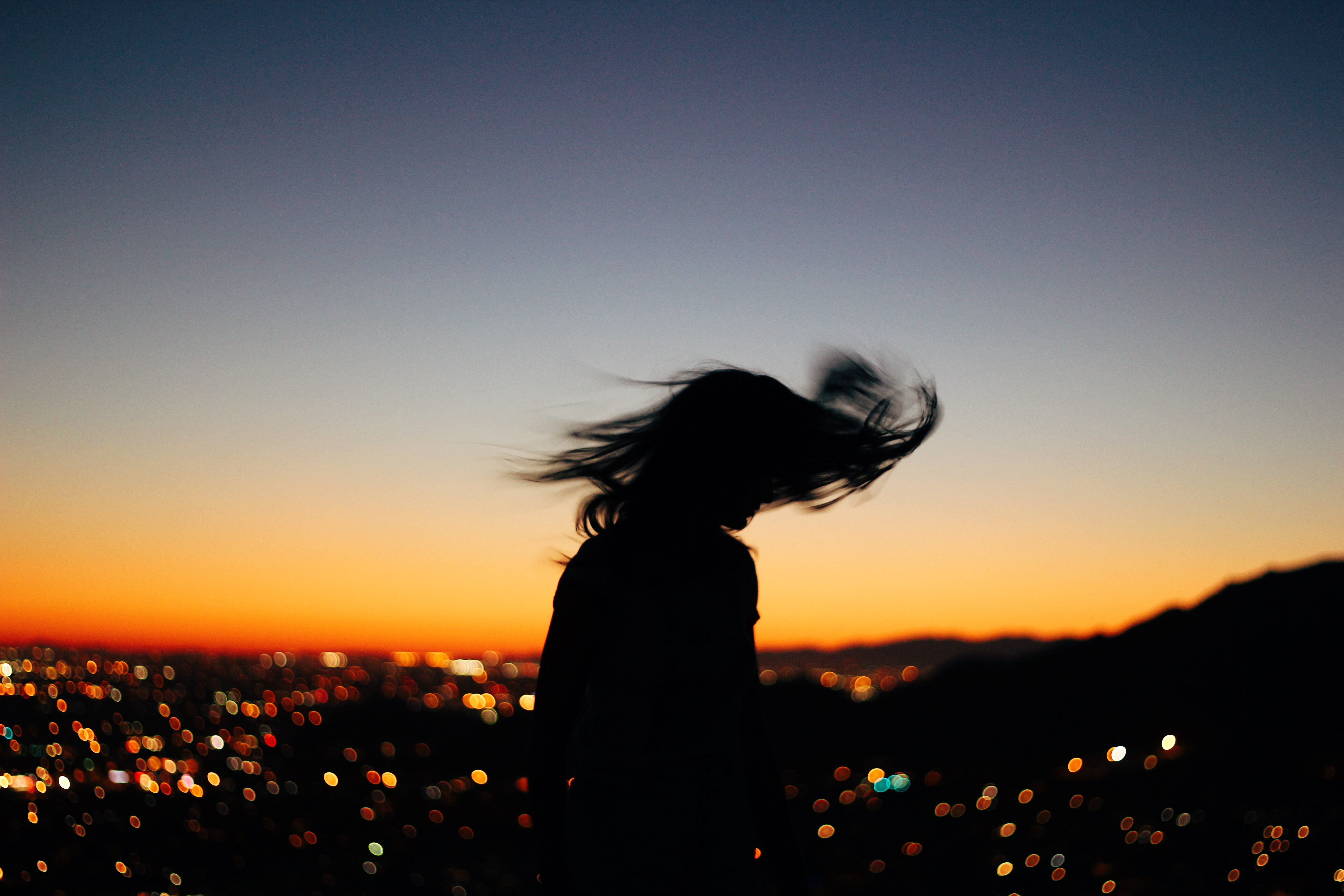 Young women spinning in the sunset