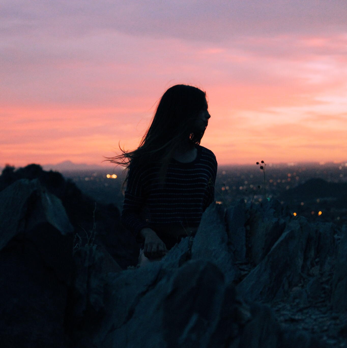 Young women in the sunset with her hair in her face