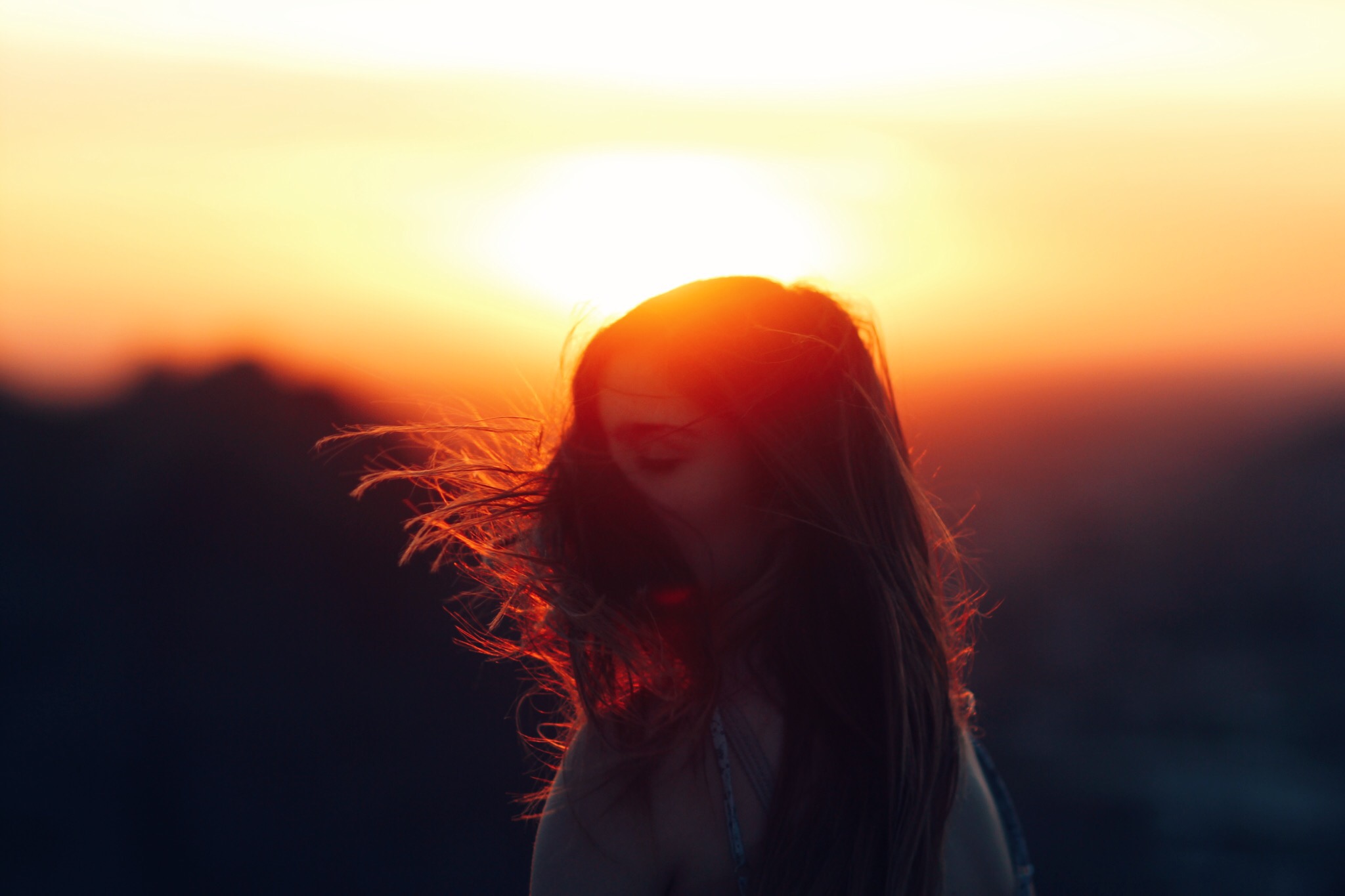 Young women in the sunset with her hair blowing in the wind 1