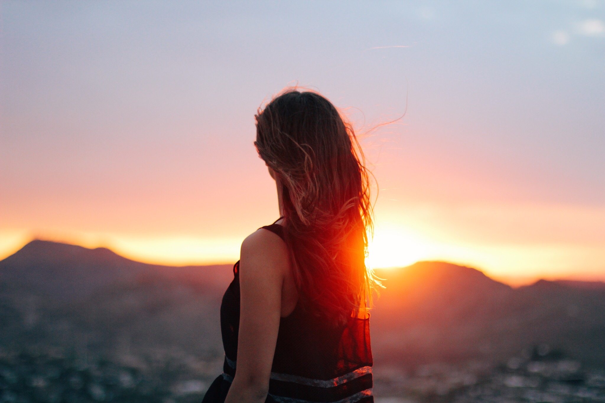 Young women in the sunset with her hair blowing in the wind 2