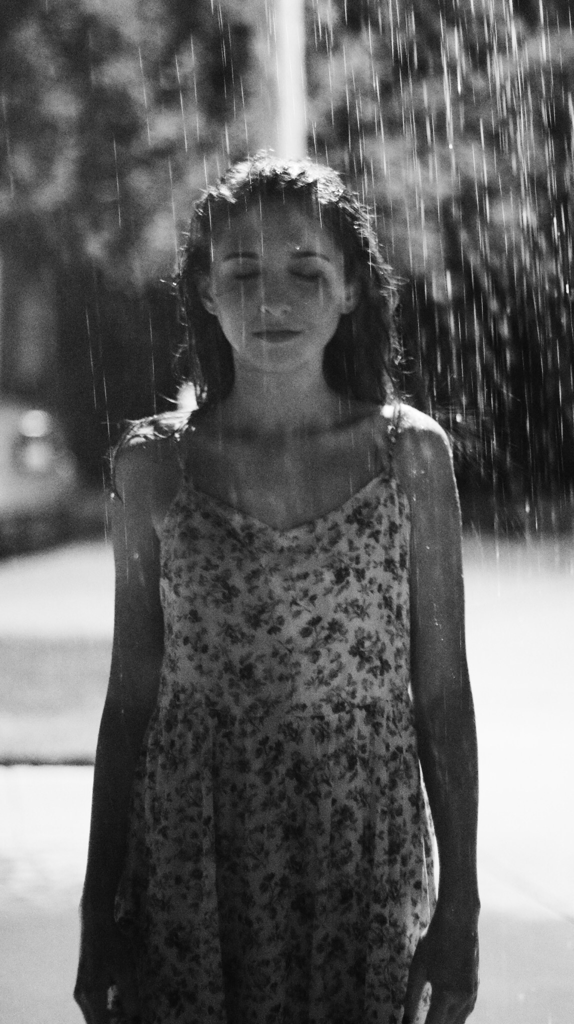 Young women in a printed dress in the rain black and white