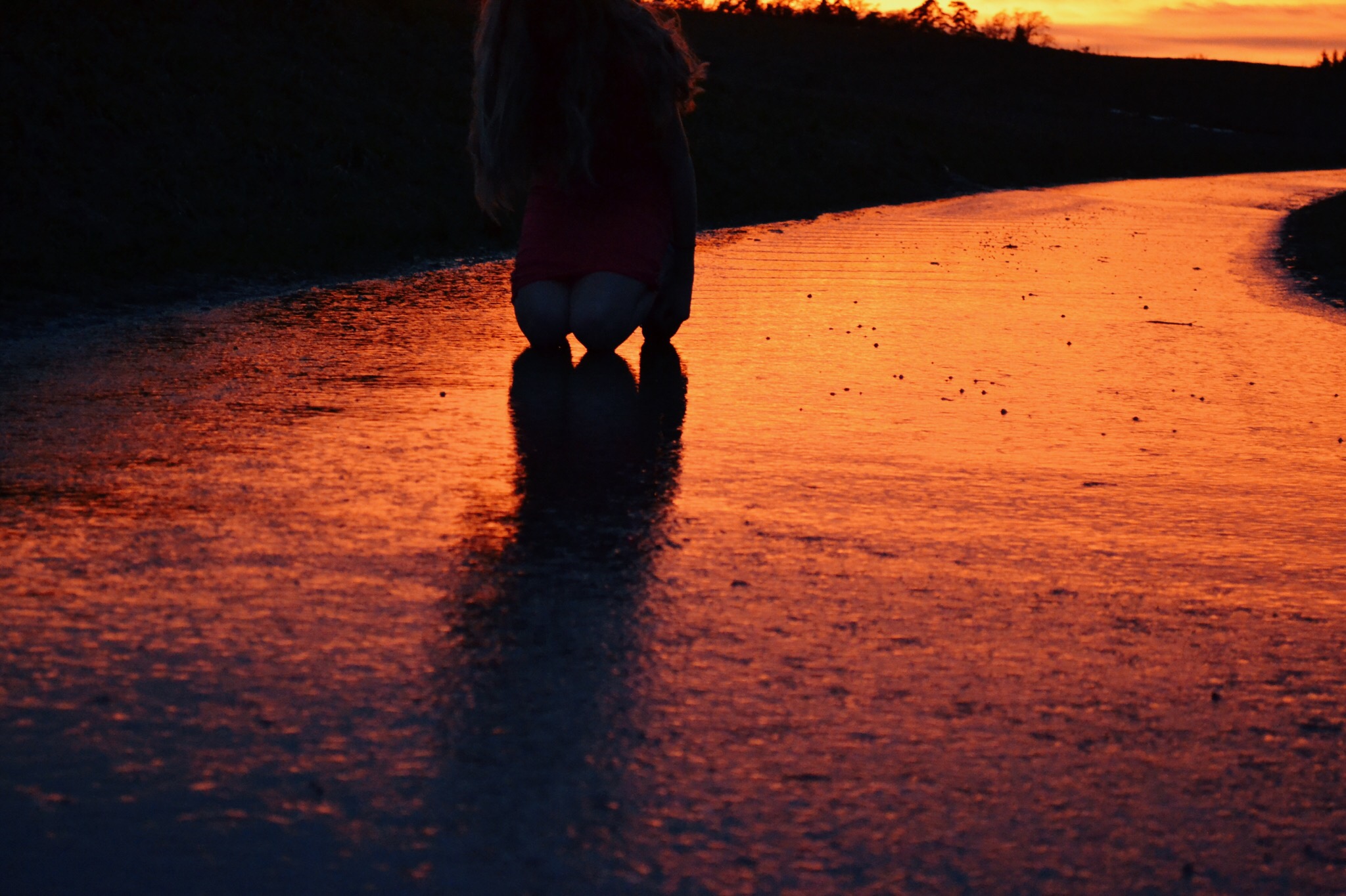 Young women posing close to a wet road with dramatic lighting