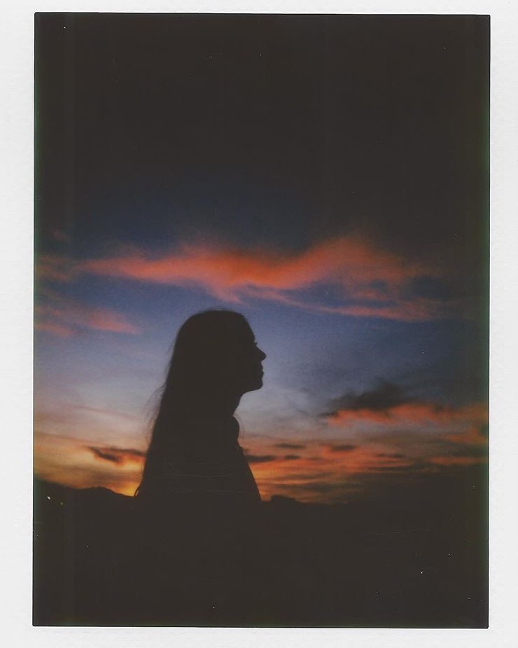 Young women in the dusk facing away from the camera shot on film