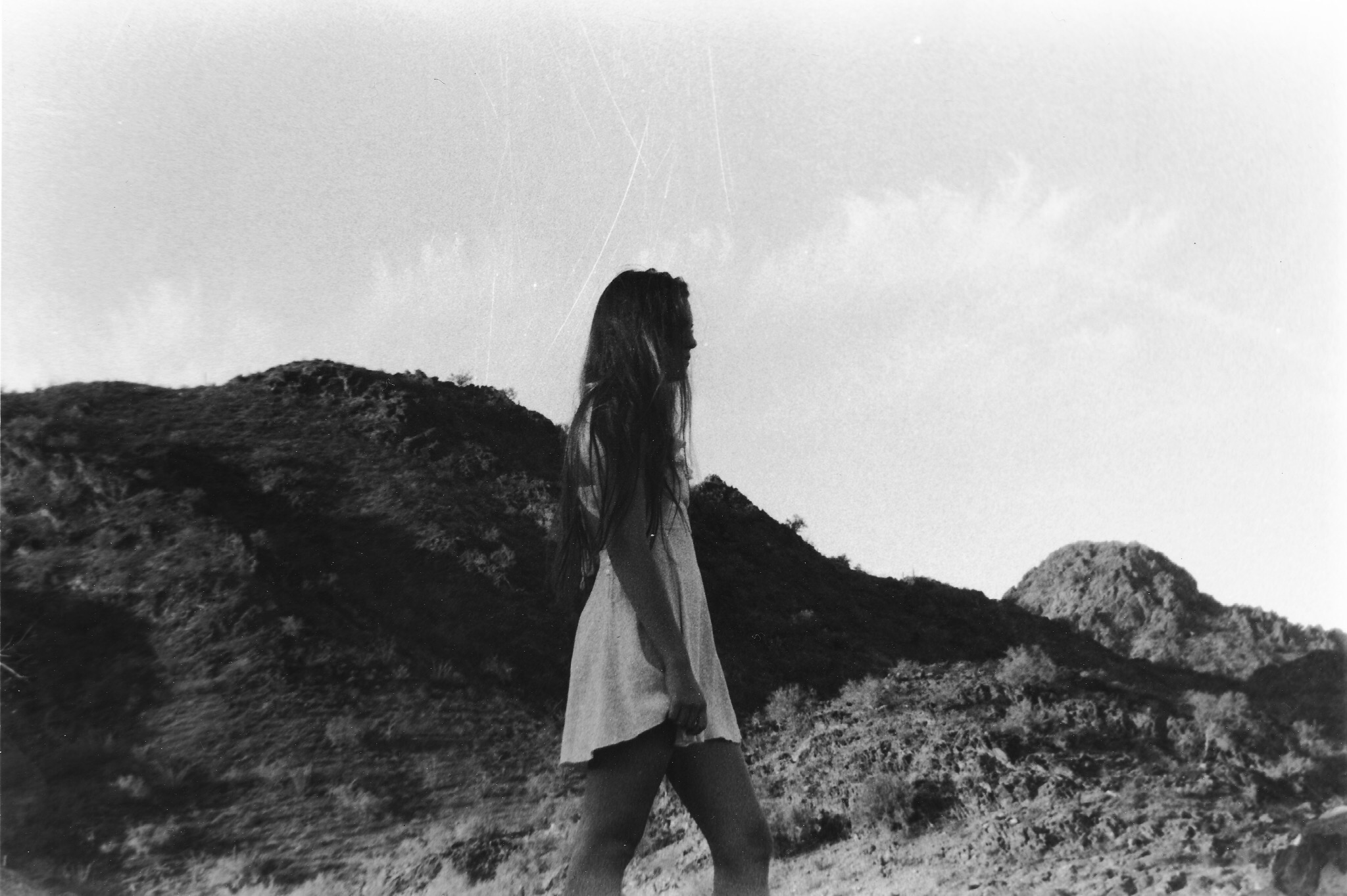 black and white young women in a white dress on a mountain shot on film