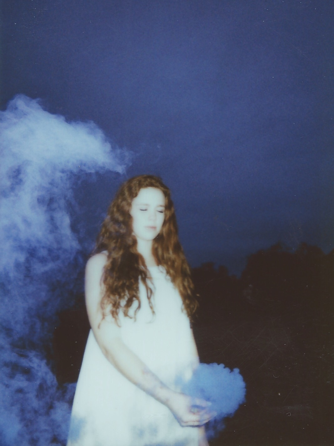 young women in a white dress on a mountain at night shot on film