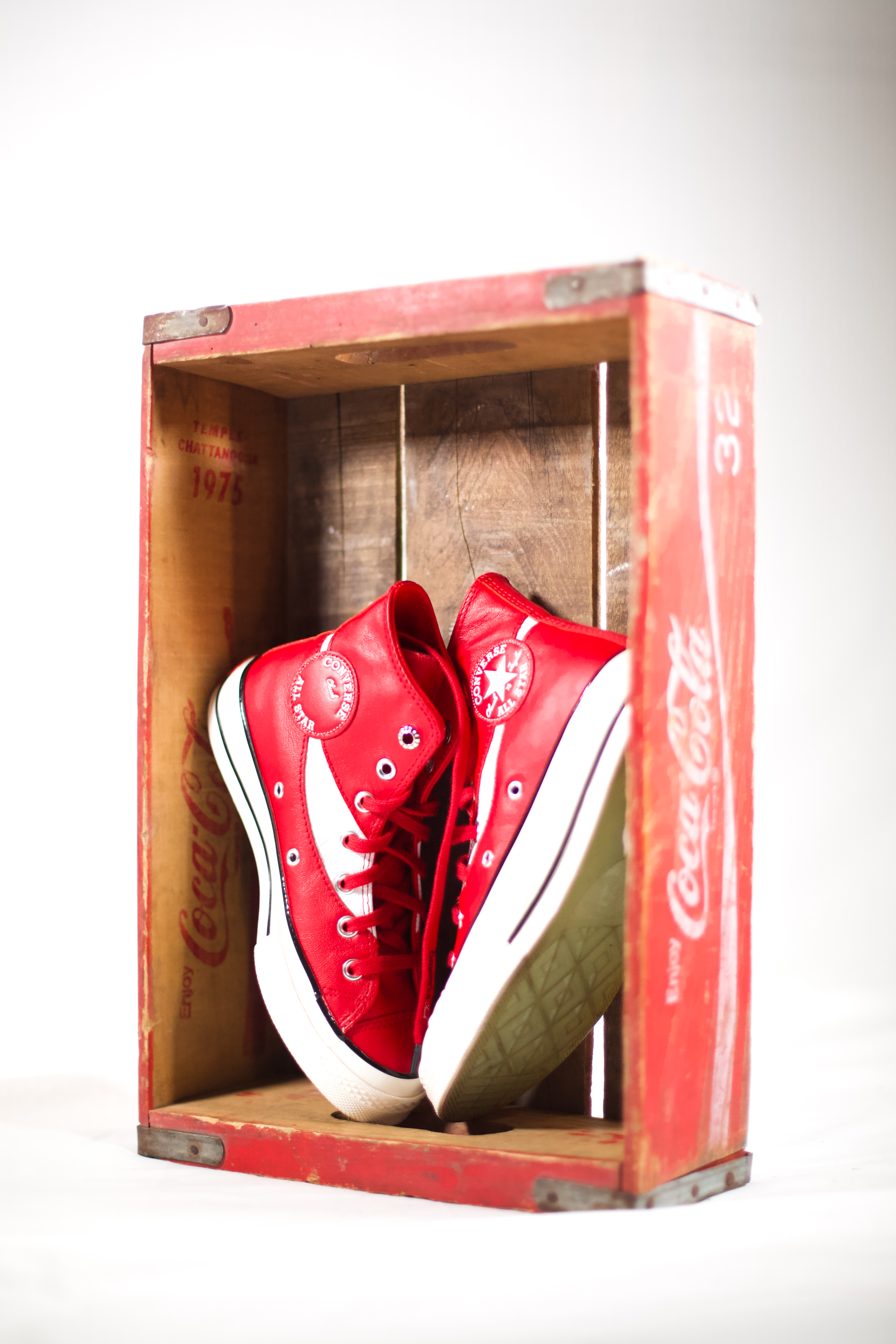 custom cocacola shoes posed in a vintage cocacola crate with a white background