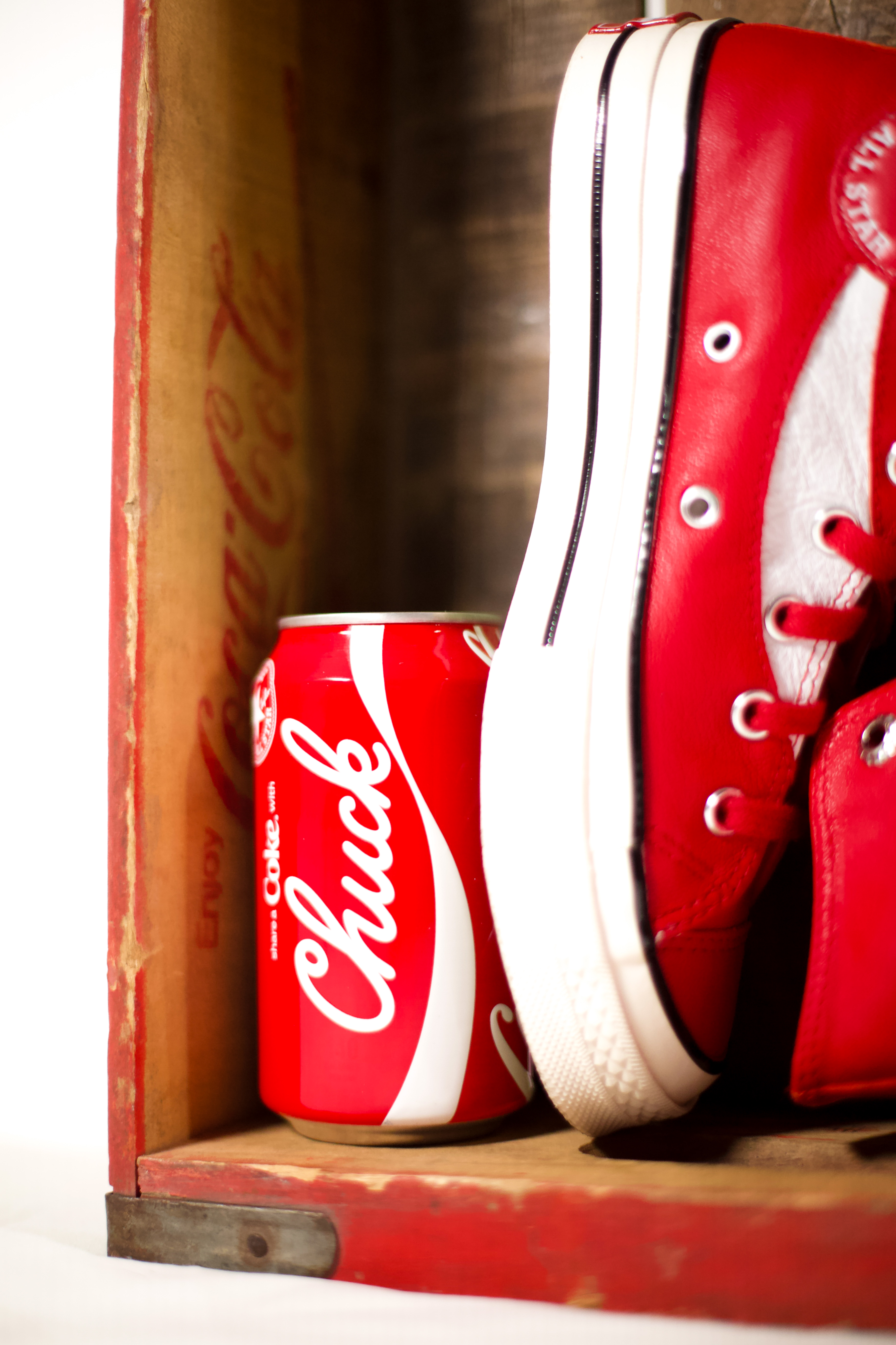 close up of custom cocacola shoes in a vintage cocacola crate with a aluminum can of cocacola in the center