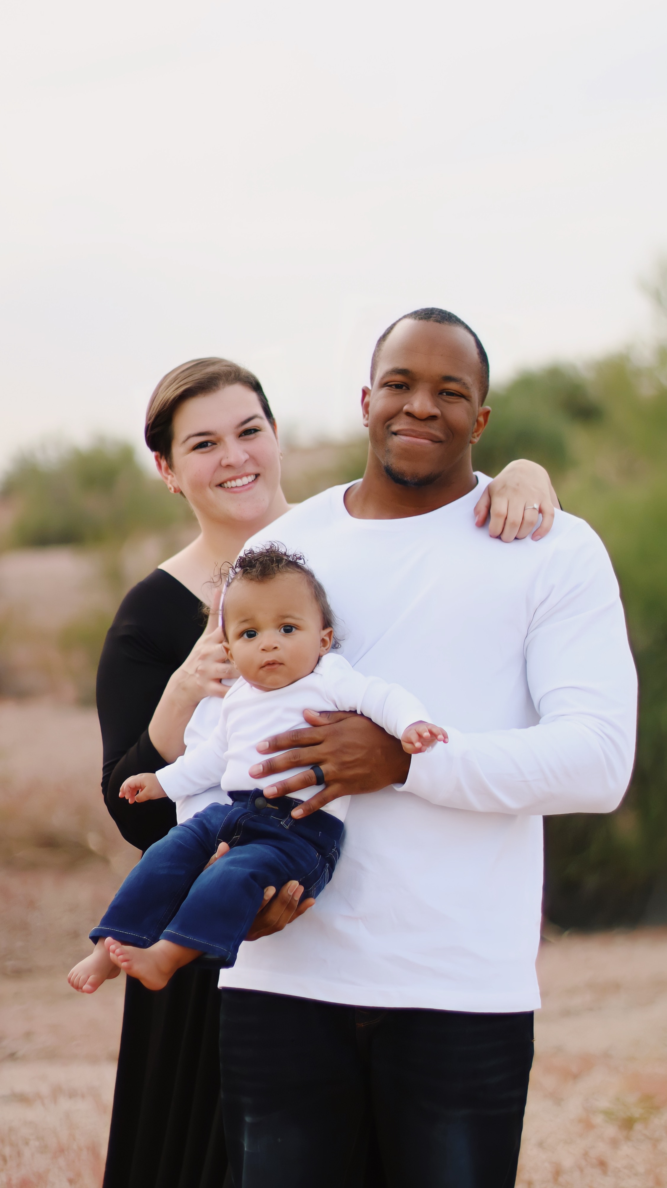 Family of three portrait on a mountain