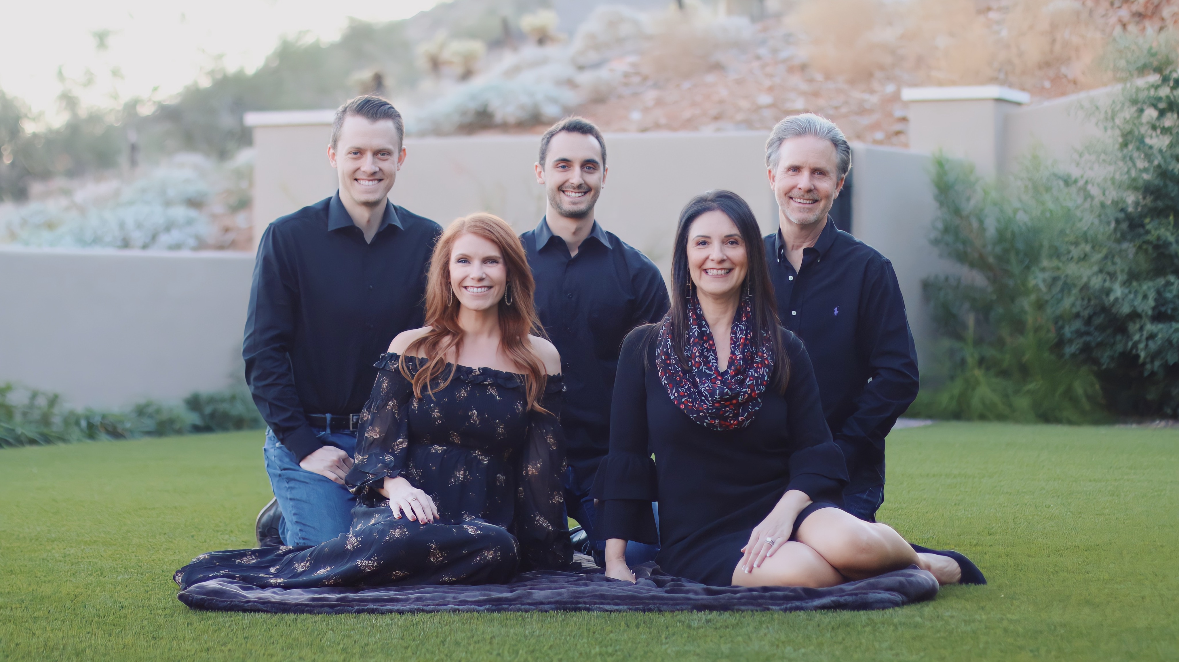 Family of five sitting on the lawn